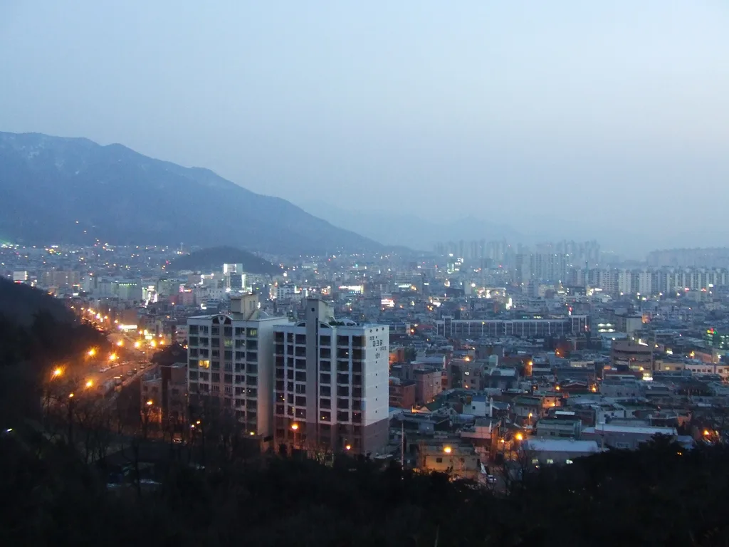 Daegu at dusk from Duryu Park, with the mountains that ring the city behind it.