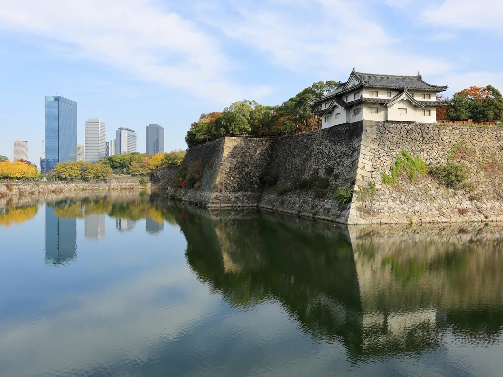 Osaka Castle across its outer moat, with the towers of Osaka Business Park behind.