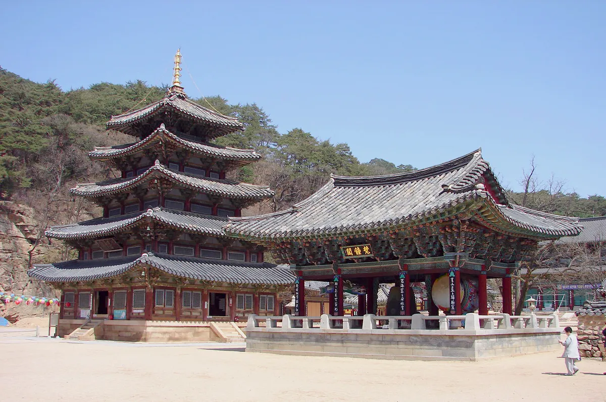 The Palsangjeon at Beopjusa, five wooden storeys rising beside the bell pavilion.