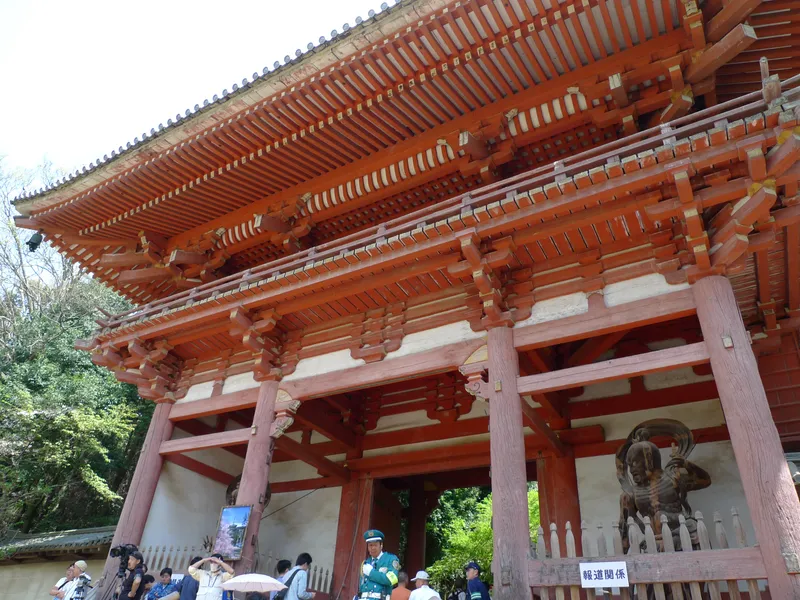 The Nio gate at Daigo-ji, its vermilion frame set among the trees.