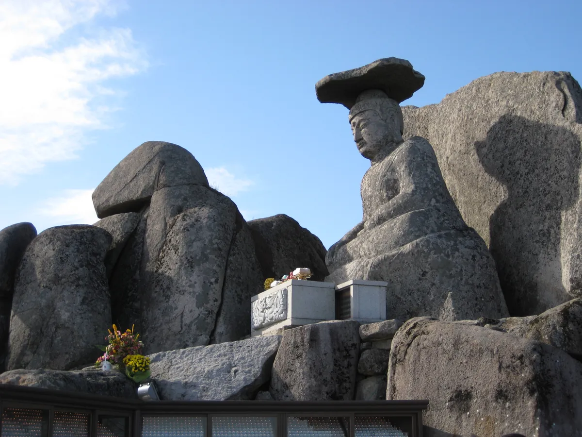 The seated stone Buddha on the summit of Gwanbong, a broad flat slab resting on its head.