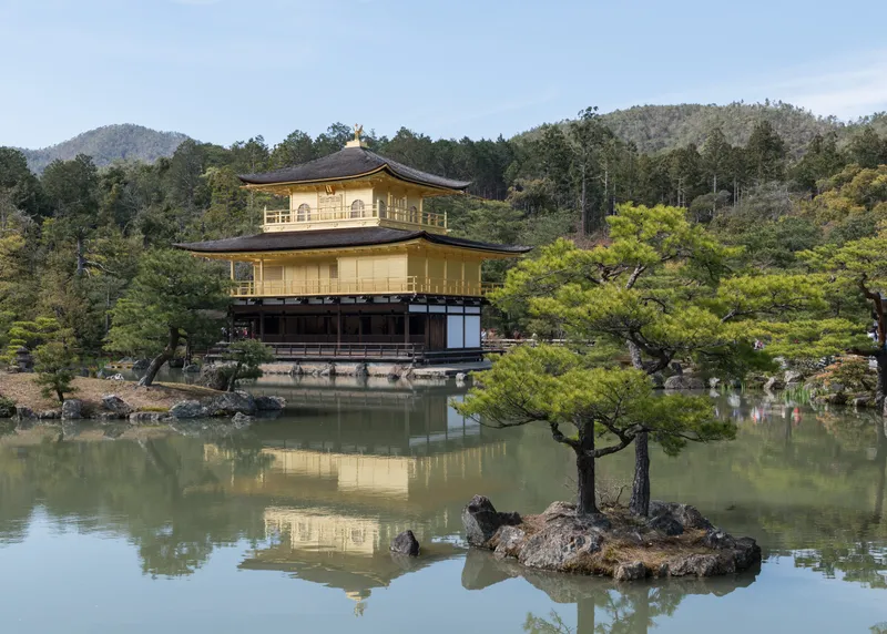 The gilded reliquary pavilion of Kinkaku-ji mirrored in its pond.