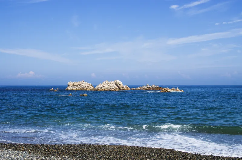 The low rock of Daewangam standing in the sea off the Gyeongju coast, waves breaking around it.
