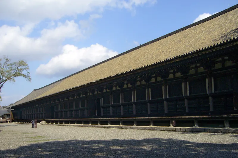 The long timber hall of Sanjusangendo running the length of its walled court.