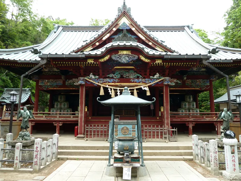 The Izuna Gongen hall of Takaosan Yakuo-in, its carved and painted eaves deep in the mountain trees
